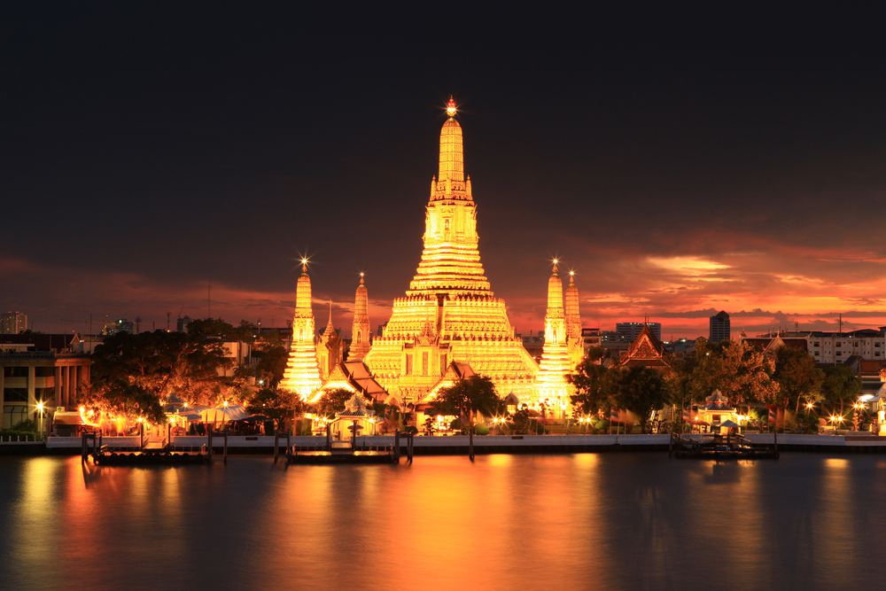 Wat Arun lit up at night across the Chao Phraya River