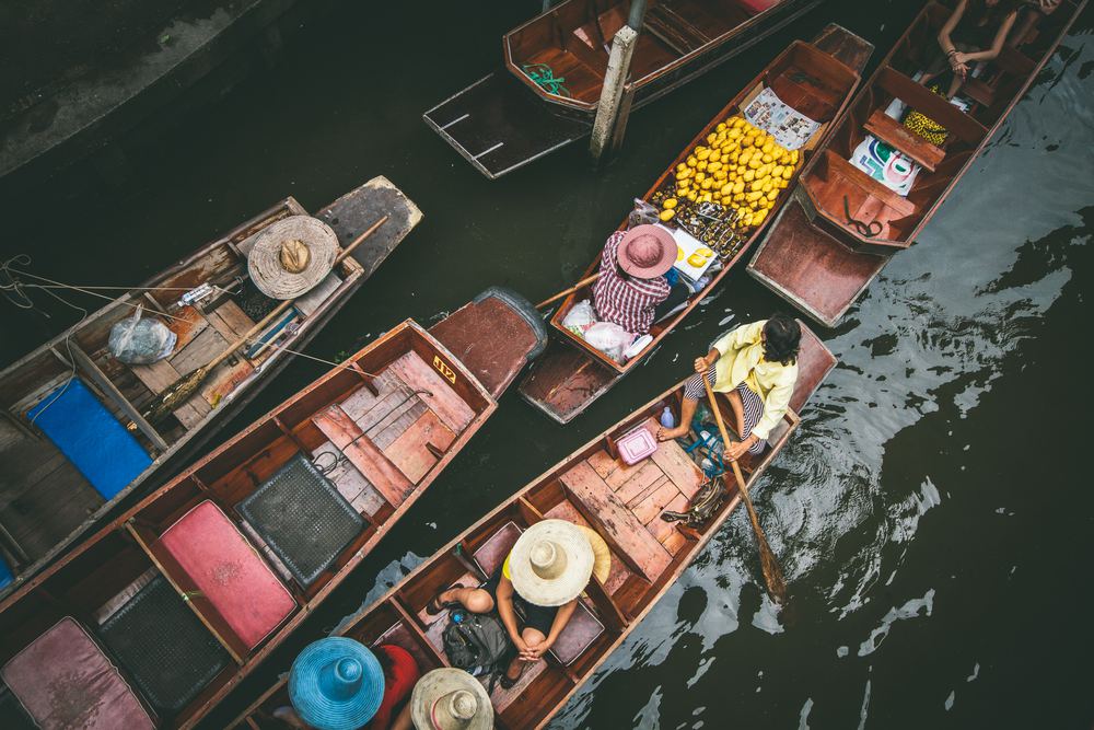 Wooden boats loaded with fruit at Damnoen Saduak Floating Market, seen from above